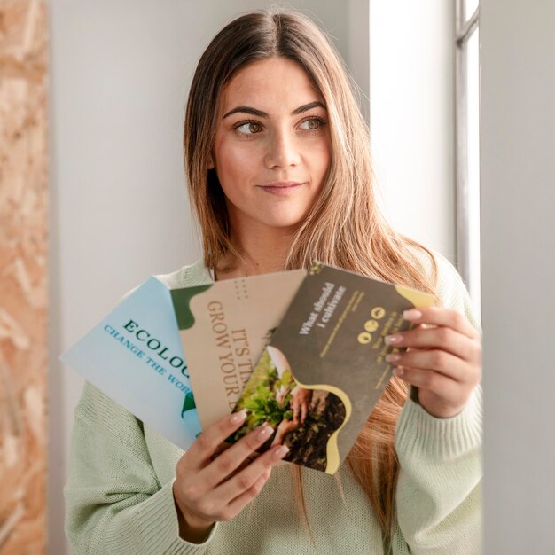 Medium shot woman holding flyers