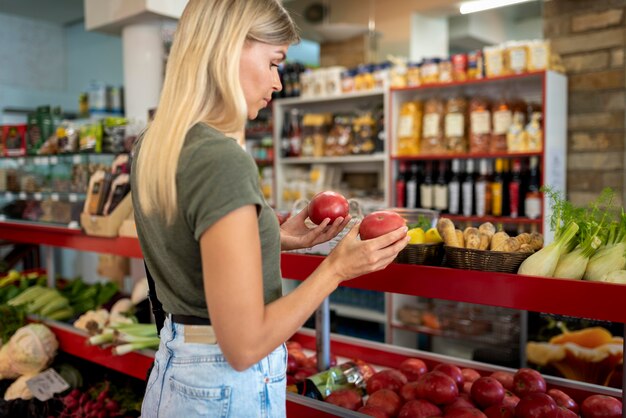 Medium shot woman holding fruits