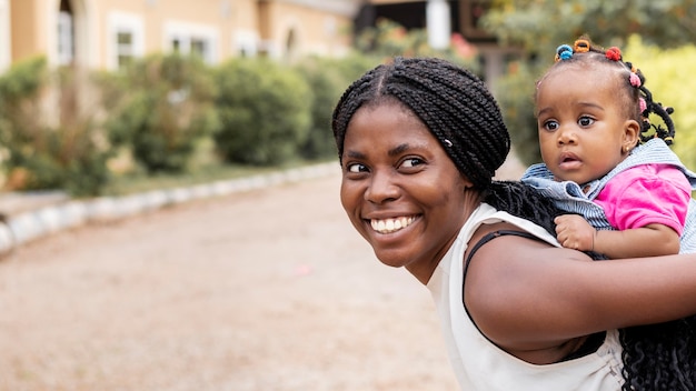 Medium shot woman holding girl