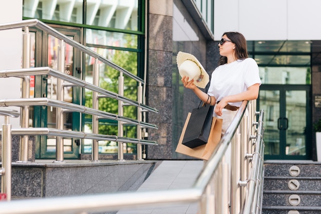 Free photo medium shot woman holding her hat