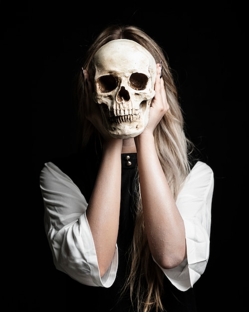 Free Photo medium shot of woman holding human skull