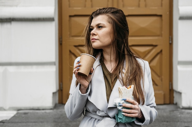 Free photo medium shot woman holding kebab