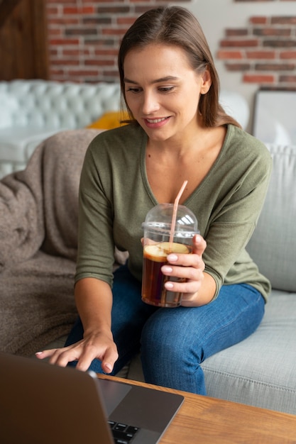 Free Photo medium shot woman holding kombucha