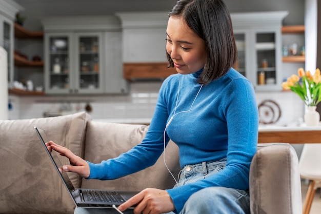 Medium shot woman holding laptop