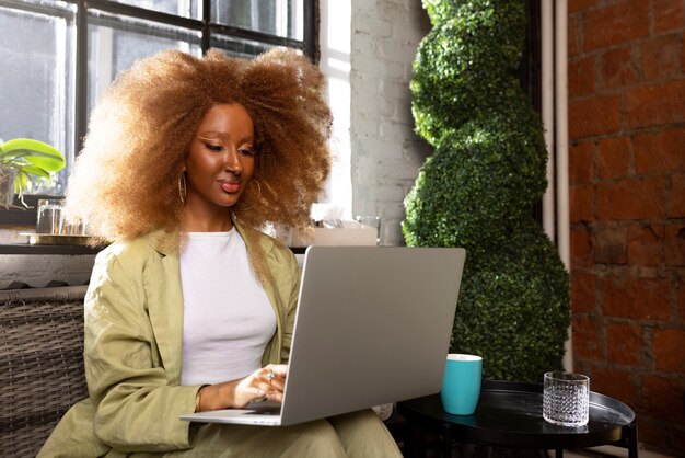 Medium shot woman holding laptop