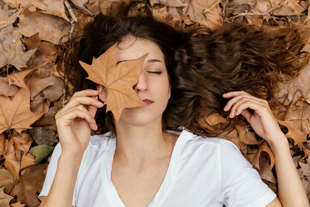 Medium shot woman holding leaf