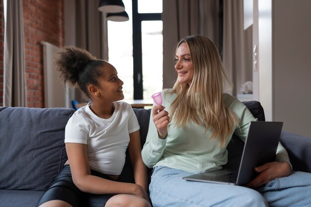 Medium shot woman holding menstrual cup