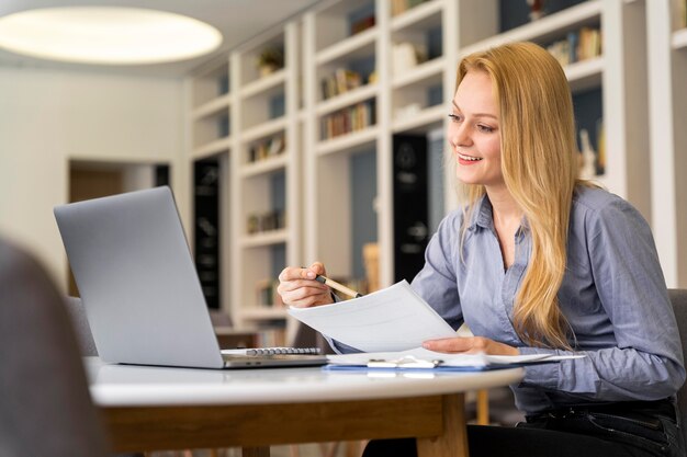 Medium shot woman holding paper