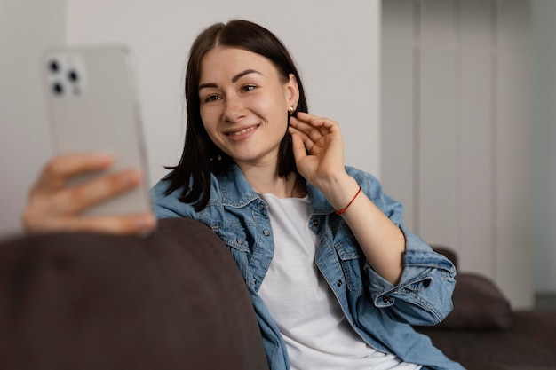 Medium shot woman holding phone