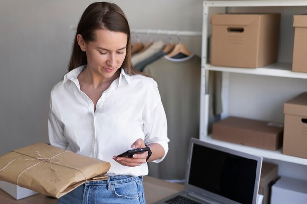 Medium shot woman holding phone