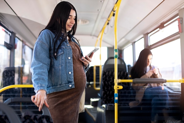 Free Photo medium shot woman holding phone