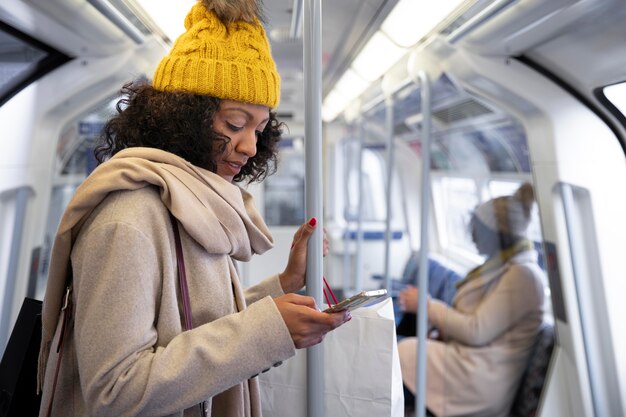 Medium shot woman holding phone