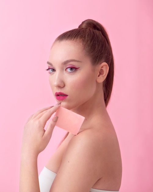 Medium shot woman holding pink card