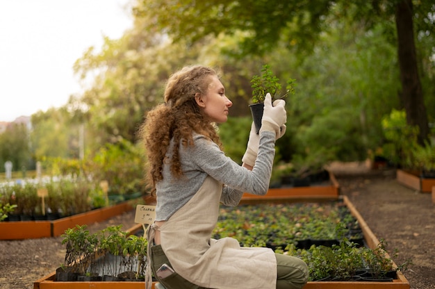 Medium shot woman holding pot