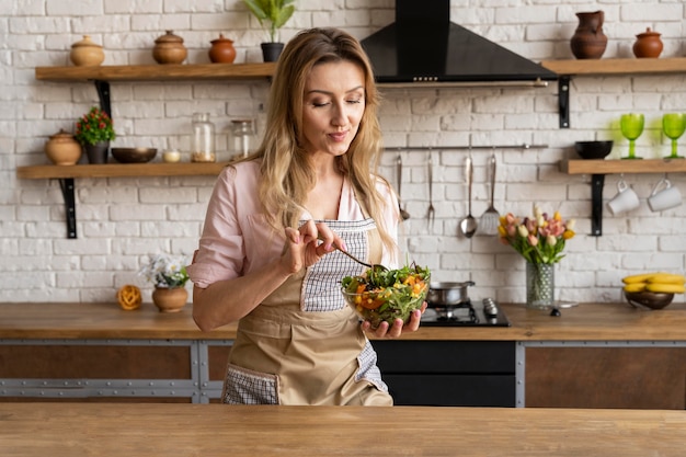 Medium shot woman holding salad bowl