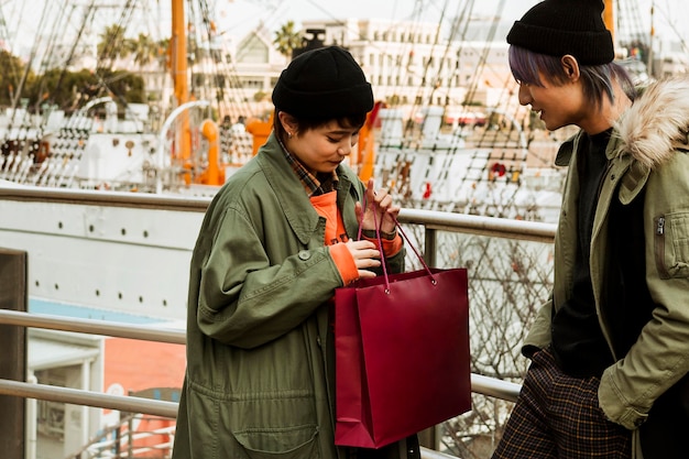 Medium shot woman holding shopping bag