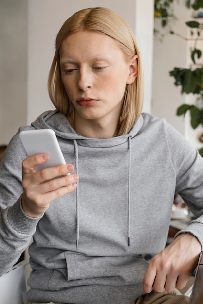 Free Photo medium shot woman holding smartphone