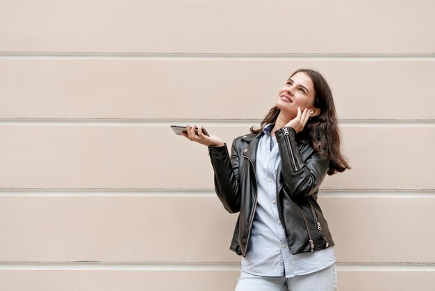 Medium shot woman holding smartphone