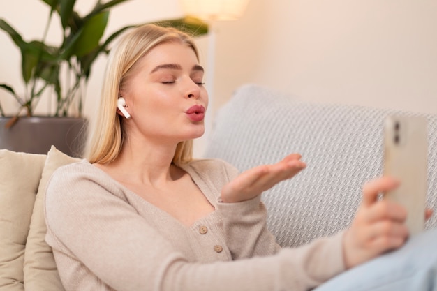 Free Photo medium shot woman holding smartphone