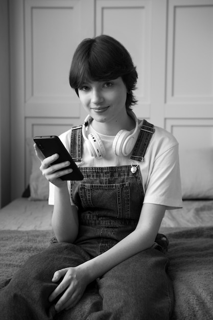 Medium shot woman holding smartphone