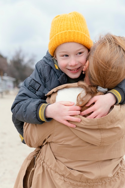 Free Photo medium shot woman holding smiley boy