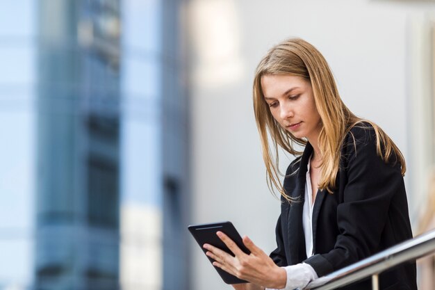 Medium shot woman holding a tablet