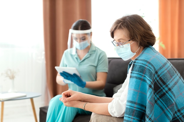 Medium shot woman holding tablet