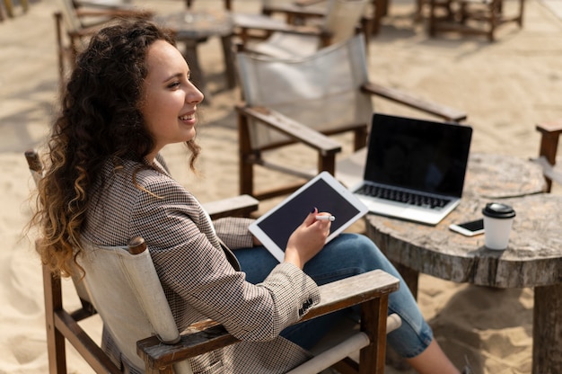 Free Photo medium shot woman holding tablet