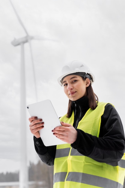 Medium shot woman holding tablet