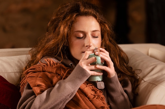 Medium shot woman holding tea cup