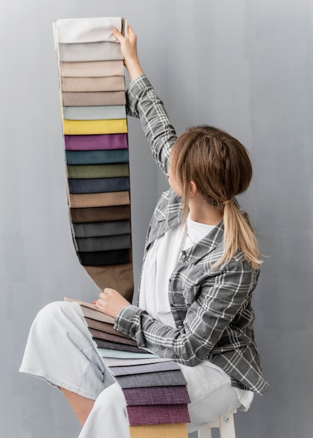 Free Photo medium shot woman holding textiles