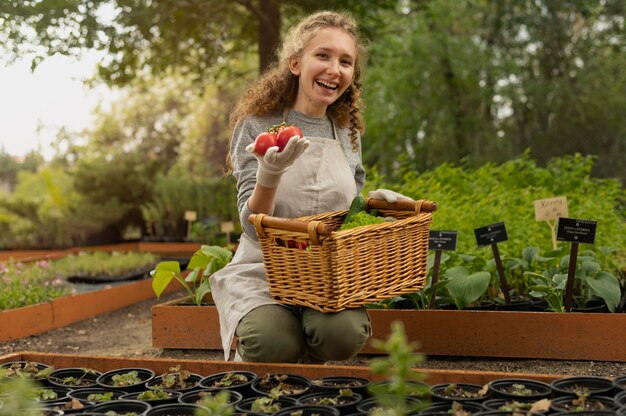 Medium shot woman holding tomatoes