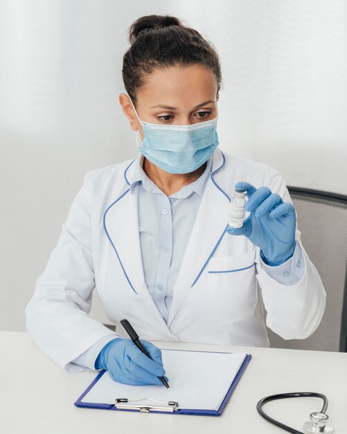 Medium shot woman holding vial