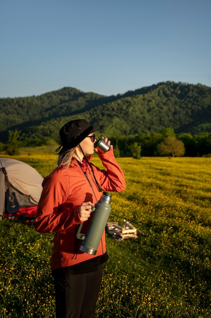 Medium shot woman holding water flask