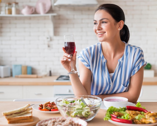 Medium shot woman holding wine glass