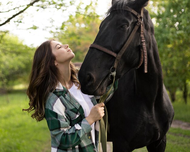 Medium shot woman and horse