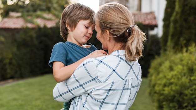 Medium shot woman hugging boy