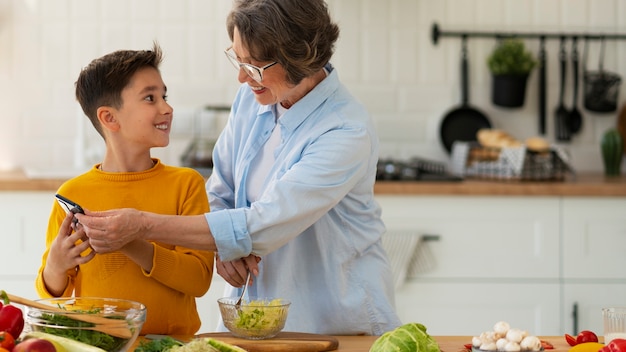 Medium shot woman and kid cooking together