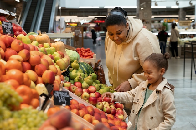 Medium shot woman and kid at market