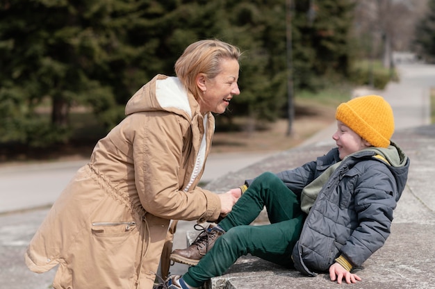 Medium shot woman and kid outside