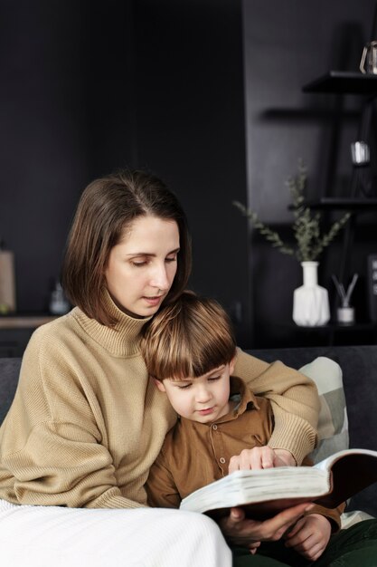 Medium shot woman and kid reading bible