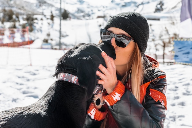 Free photo medium shot woman kissing dog