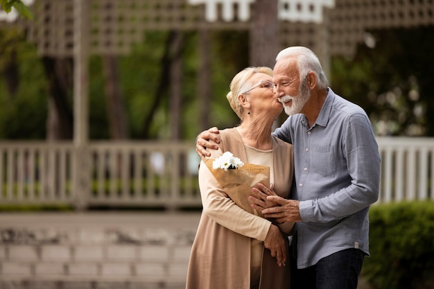 Medium shot woman kissing man on cheek