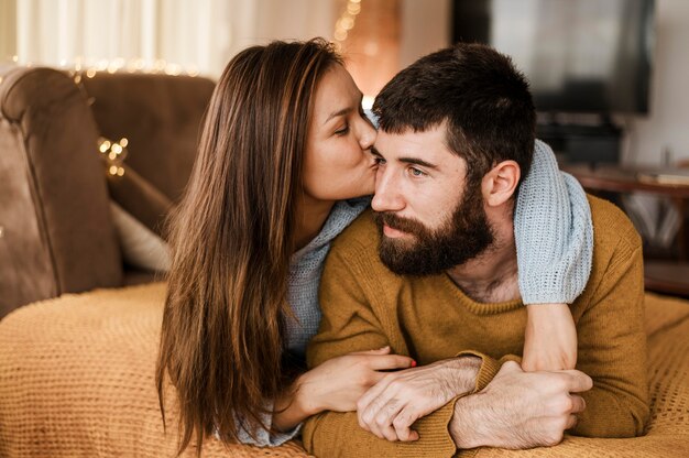 Medium shot woman kissing man