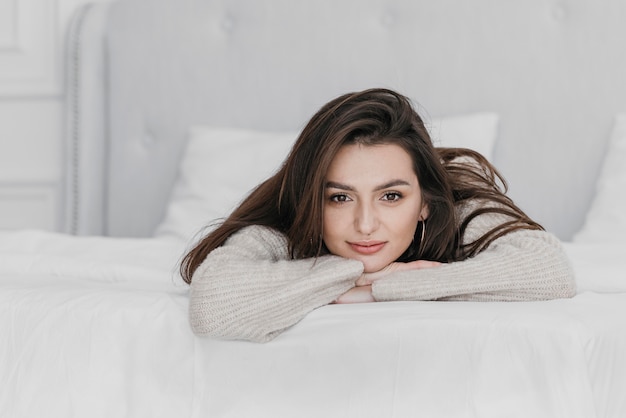 Medium shot woman laying in bed