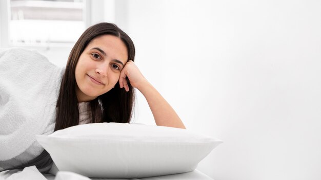 Medium shot woman laying on pillow