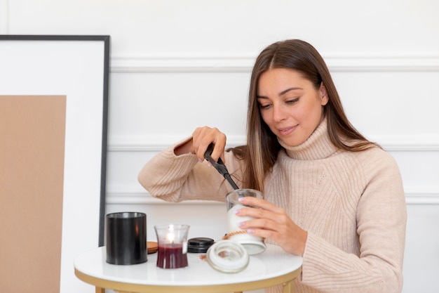 Medium shot woman lighting candle