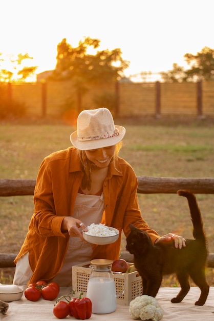 Medium shot woman living at farmhouse