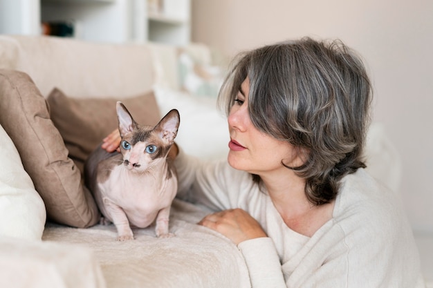 Medium shot woman looking at cat