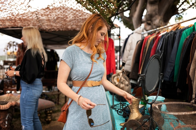 Medium shot woman looking at clothes